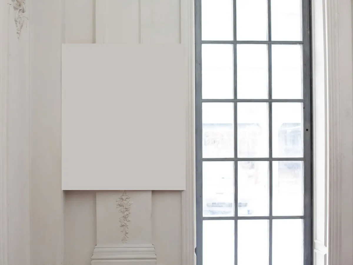 Blank banner hanging on a wall beside a window