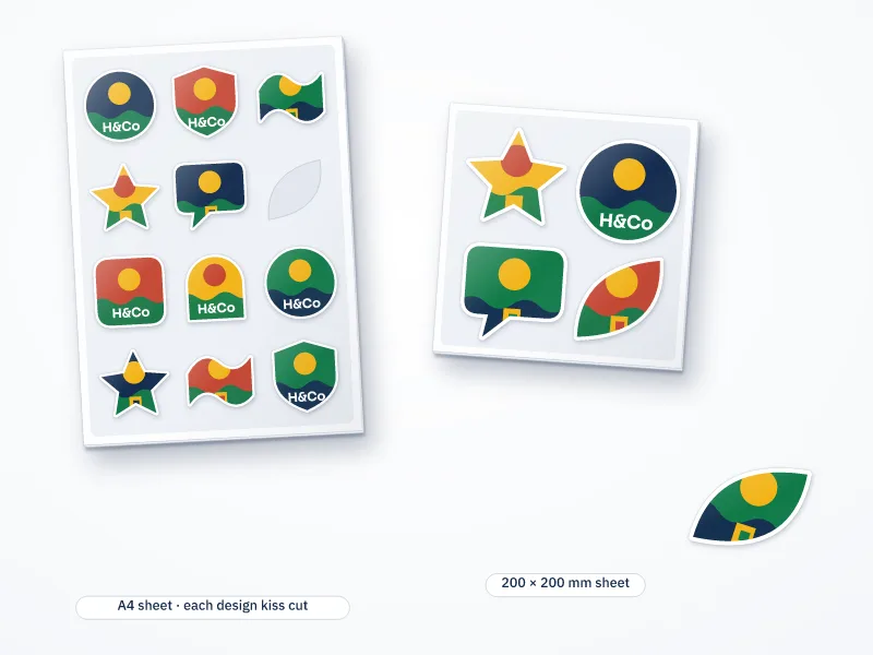 Illustration of an A4 and a 200 by 200 mm sheet of kiss-cut stickers in assorted shapes, with one sticker peeled off its backing