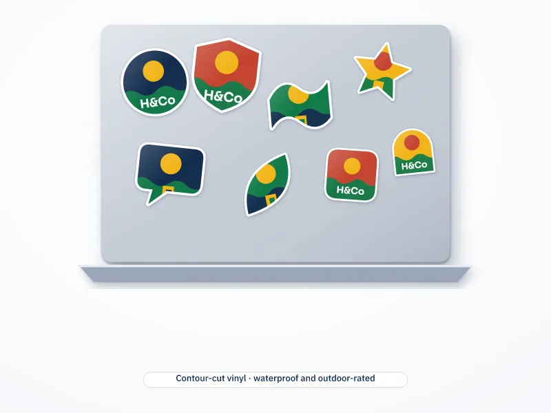 Illustration of a plain laptop lid covered in contour-cut vinyl stickers in assorted shapes