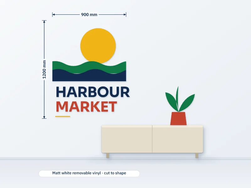 Illustration of a 900 by 1200 mm wall decal of a sun, waves and lettering applied straight to a wall above a sideboard with a plant
